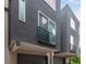 Exterior of modern townhomes with dark color schemes, balconies, and attached garages at 4922 Lowell Blvd # 2, Denver, CO 80221