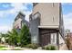 Attractive townhome featuring a private balcony and a stylish facade with stone accents near the entry at 4922 Lowell Blvd # 2, Denver, CO 80221