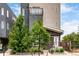 Modern townhome exterior with multi-story design and landscaped front yard at 4922 Lowell Blvd # 2, Denver, CO 80221
