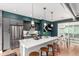 Open concept kitchen with an island, stainless steel appliances, a dining area, and hardwood floors at 4922 Lowell Blvd # 2, Denver, CO 80221