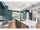 Open concept kitchen with an island, stainless steel appliances, and dark blue accent walls at 4922 Lowell Blvd # 2, Denver, CO 80221