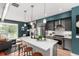 Bright open-concept area features a modern kitchen, stylish island seating, and a fireplace in the living area at 4922 Lowell Blvd # 2, Denver, CO 80221