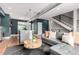 Cozy living area with a leather sofa, dark hardwood floors, an open concept view to the kitchen, and natural light at 4922 Lowell Blvd # 2, Denver, CO 80221