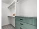 Walk-in closet with custom shelving, drawers, and hanging space with grey carpet at 4922 Lowell Blvd # 2, Denver, CO 80221