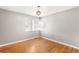 Spacious bedroom with hardwood floors and a large window at 2610 Poplar St, Denver, CO 80207