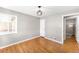 Bright bedroom with hardwood floors, window coverings, and access to bathroom at 2610 Poplar St, Denver, CO 80207