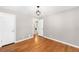 Bedroom with hardwood floors and access to bathroom at 2610 Poplar St, Denver, CO 80207