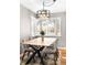 Open dining area has wood floors, a modern table and chairs, and great natural light at 2610 Poplar St, Denver, CO 80207