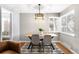 Dining area featuring wood floors, a modern table, and large windows with bright, natural light at 2610 Poplar St, Denver, CO 80207