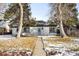Charming single-story home with white brick exterior and a well-maintained front yard at 2610 Poplar St, Denver, CO 80207