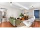 The inviting living room with hardwood floors, neutral walls, beamed ceilings, and stylish furniture at 2610 Poplar St, Denver, CO 80207
