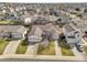 Aerial view of a beautiful home featuring a large garage and mature trees at 20630 E Ithaca Pl, Aurora, CO 80013