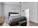 Comfortable bedroom with wood floors, gray walls, a queen-sized bed, and an ensuite bathroom for added privacy at 20630 E Ithaca Pl, Aurora, CO 80013