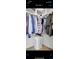 Organized walk-in closet with ample storage, multiple racks, and shelves to keep clothes and accessories tidy at 20630 E Ithaca Pl, Aurora, CO 80013