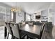 Open-concept dining room featuring modern chandelier and sliding glass doors for abundant natural light at 20630 E Ithaca Pl, Aurora, CO 80013