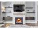 Close-up of a modern fireplace with a mounted TV and decorative shelves, creating a cozy atmosphere at 20630 E Ithaca Pl, Aurora, CO 80013