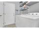 The laundry room features a white washer and dryer, shelves, and white door at 20630 E Ithaca Pl, Aurora, CO 80013