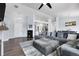 Open-concept living area with hardwood floors, modern furnishings, and access to kitchen at 20630 E Ithaca Pl, Aurora, CO 80013
