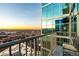 Apartment balcony with a distant city view at sunset from a high rise at 1700 Bassett St # 2117, Denver, CO 80202