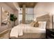 Serene bedroom featuring a comfortable bed, abstract art, and a large window offering cityscape views at 1700 Bassett St # 2117, Denver, CO 80202