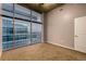 Clean, empty bedroom with carpet flooring and a large window with city views at 1700 Bassett St # 2117, Denver, CO 80202
