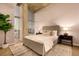 Comfortable bedroom showcasing a plush bed, neutral tones, and a large window with city views at 1700 Bassett St # 2117, Denver, CO 80202