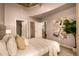 Inviting bedroom featuring neutral tones, large windows, and connecting doors to closet and bath at 1700 Bassett St # 2117, Denver, CO 80202