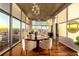 Open concept dining area with city views, modern lighting, and beautiful hardwood floors at 1700 Bassett St # 2117, Denver, CO 80202