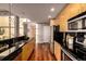 Modern kitchen featuring stainless steel appliances, black countertops, and wood flooring at 1700 Bassett St # 2117, Denver, CO 80202