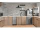 Well-equipped kitchen featuring a beverage fridge, microwave, sink, dishwasher, and plenty of cabinets at 1700 Bassett St # 2117, Denver, CO 80202