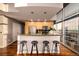 Kitchen featuring modern bar stools and expansive city views from large windows at 1700 Bassett St # 2117, Denver, CO 80202