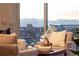 Bright living room featuring comfortable seating and mountain views from large windows at 1700 Bassett St # 2117, Denver, CO 80202