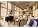 Open-concept living area features hardwood floors, stylish furniture, and a well-equipped kitchen nearby at 1700 Bassett St # 2117, Denver, CO 80202