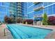 Beautiful outdoor pool at condo complex with stunning views of the building and landscaping at 1700 Bassett St # 2117, Denver, CO 80202