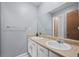 Bright bathroom featuring a double vanity and a large mirror at 55429 E 31St Ave, Strasburg, CO 80136