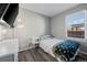 Cozy bedroom featuring a single bed and a window with natural light creating a comforting space at 55429 E 31St Ave, Strasburg, CO 80136