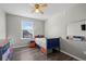 Cozy bedroom with hardwood floors, ample sunlight, and charming decor at 55429 E 31St Ave, Strasburg, CO 80136