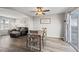 Open dining area seamlessly connected to the living room with lots of natural light and neutral walls at 55429 E 31St Ave, Strasburg, CO 80136