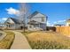 Charming two-story home featuring a fenced backyard and a well-maintained lawn on a beautiful day at 55429 E 31St Ave, Strasburg, CO 80136