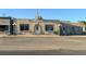 Charming storefront with stucco facade, large windows, and decorative street lamps at 55429 E 31St Ave, Strasburg, CO 80136