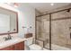 Bathroom featuring a glass-enclosed tiled shower, modern vanity, and neutral color scheme at 5761 W 50Th Ave, Denver, CO 80212