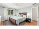 Comfortable bedroom featuring a large bed, ceiling fan, and bright natural light from the window at 5761 W 50Th Ave, Denver, CO 80212