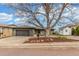 Charming single-story home with well-maintained lawn, mature trees, and attached two car garage at 5761 W 50Th Ave, Denver, CO 80212