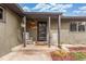 Inviting front porch featuring two rocking chairs and a hanging flower basket for curb appeal at 5761 W 50Th Ave, Denver, CO 80212