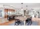 Gourmet kitchen with large island, stainless steel appliances, granite countertops, and a dining area at 5761 W 50Th Ave, Denver, CO 80212