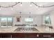 Close-up of the kitchen island featuring a gas cooktop and expansive countertops with views at 5761 W 50Th Ave, Denver, CO 80212