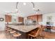 Well-appointed kitchen with stainless steel appliances, granite countertops, and a large central island with seating at 5761 W 50Th Ave, Denver, CO 80212