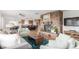 Cozy living room with a stone fireplace, seamlessly connected to the kitchen and dining area at 5761 W 50Th Ave, Denver, CO 80212