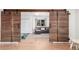 Inviting living room with wood sliding barn doors, a comfortable gray couch, and neutral color palette at 5761 W 50Th Ave, Denver, CO 80212