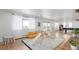 Bright recreation room featuring large windows, playful decor, and access to a patio at 5761 W 50Th Ave, Denver, CO 80212